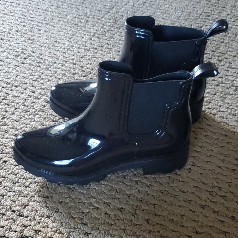 Pair of rubber boots along with a pair of socks.